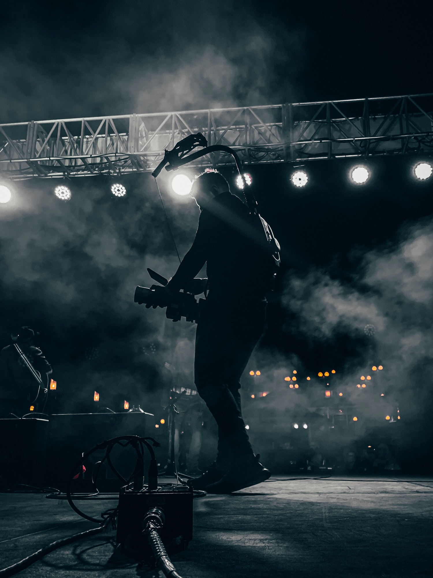 A Videographer Onstage At A Concert Filming A Band