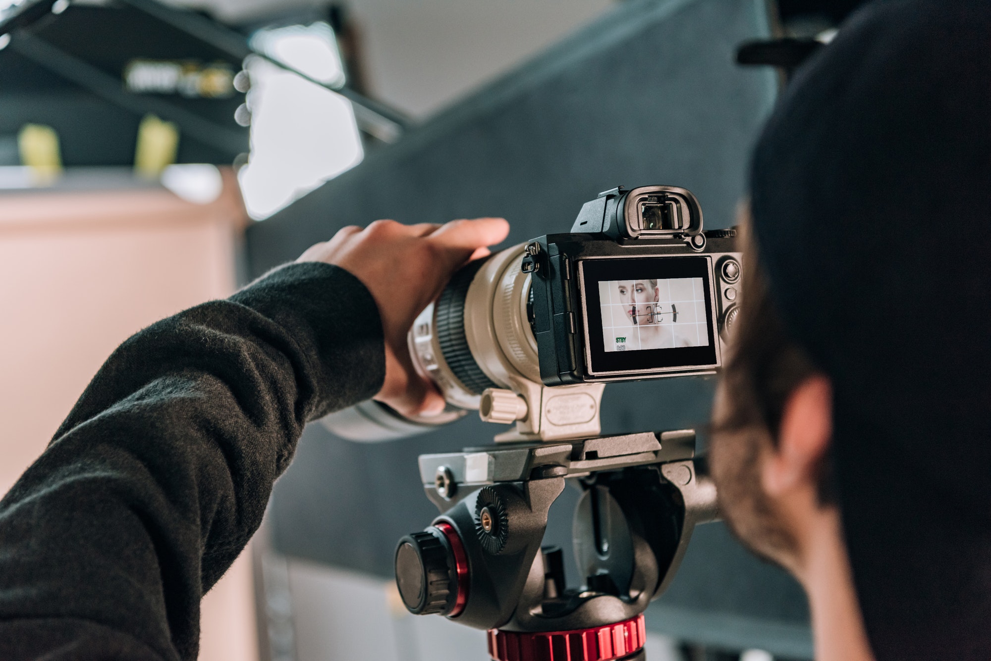 Selective Focus Of Videographer Filming Woman In Photo Studio